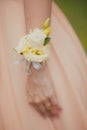 Bridesmaid with boutonniere on hand.